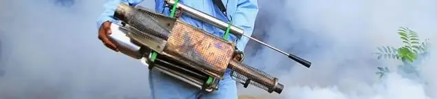 Fumigation technician using a fogger for deep pest treatment in Ann Arbor, MI